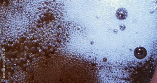 Beer is poured with foam in close-up