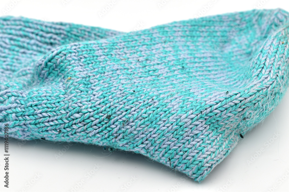 Fototapeta premium Warm sock knitted by hand from woolen thread.