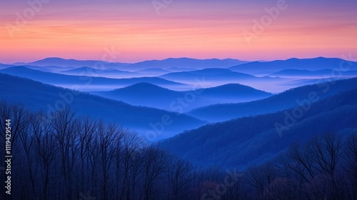 Serene mountain landscape at dawn with layered hills and a misty atmosphere.