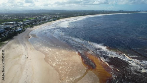 Aerial views of muddy waters from Cudgen Creek flowing in to the sea at Kingscliff headland seawall along the east coast of New South Wales, Australia photo