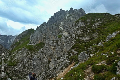 Austrian Alps - view of the peaks Elfer and tourist photographer from the footpath to Elfer in Stubai Alps