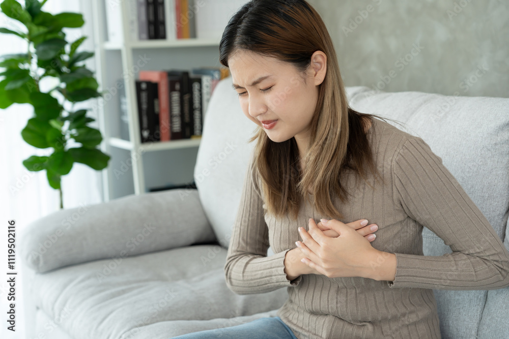 hand hold chest with heart attack symptoms, asian woman have chest pain caused by heart disease, leak, dilatation, enlarged coronary heart, press on the chest with a painful expression hand hold chest with heart attack symptoms, asian woman have chest pain caused by heart disease, leak, dilatation, enlarged coronary heart, press on the chest with a painful expression
