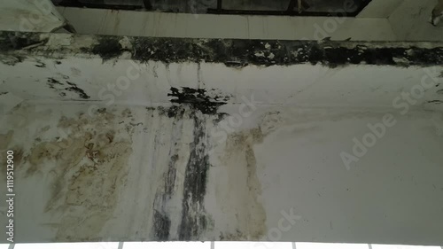 Stains on the wall, Corrosion of the wall due to rain, Corroded cement wall.Creamy textured white wall with rough and faded streaks on the concrete cement.Stairs with Stainless Steel Staircase Railing