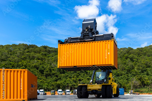 Reach stacker cargo forklift container box import export logistic transportation industrial, Reach stacker pick up container, Reach stacker container loader crane lifting maritime cargo container.