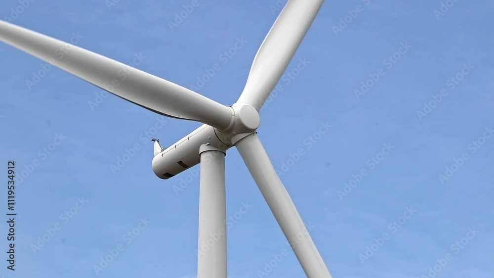 Scenic view of a field of windmills under a blue sunny day Scenic view of a field of windmills under a blue sunny day