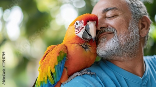 Pet friendly outdoor interaction. A man smiles affectionately with a colorful parrot perched on his shoulder. photo