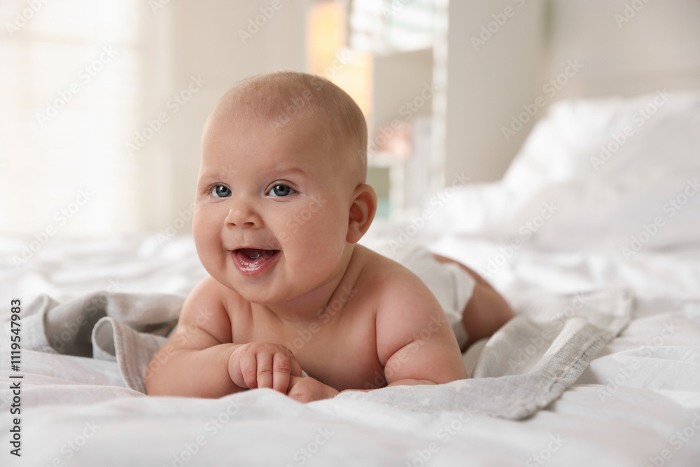 Cute little baby lying on bed indoors Cute little baby lying on bed indoors