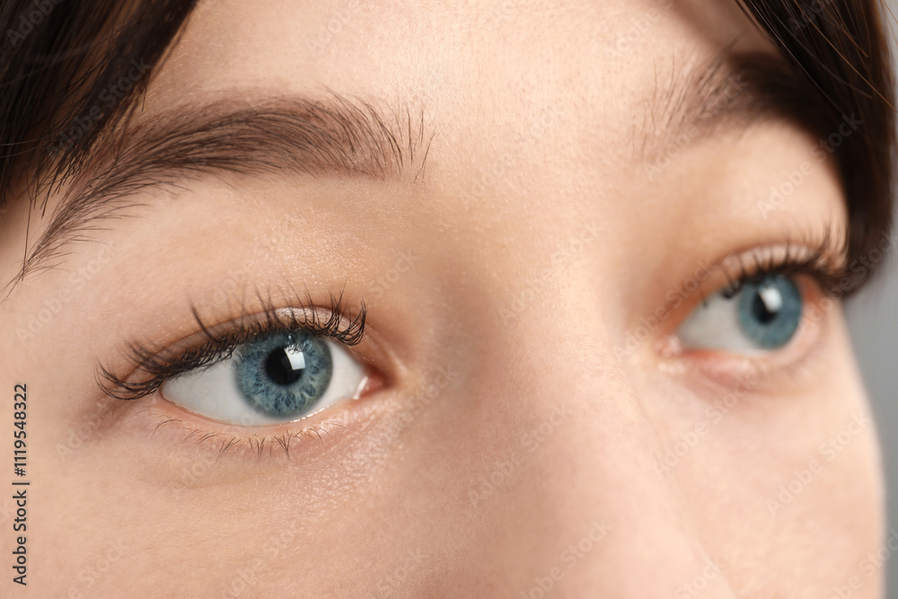 Fototapeta premium Closeup view of young woman with beautiful blue eyes