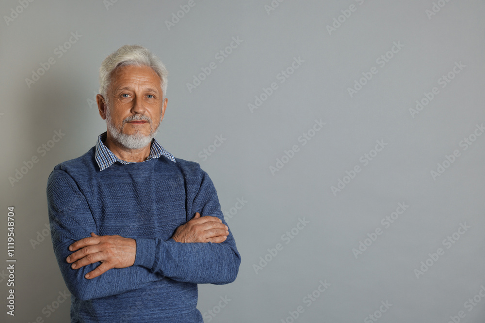 Portrait of senior man on grey background, space for text Portrait of senior man on grey background, space for text