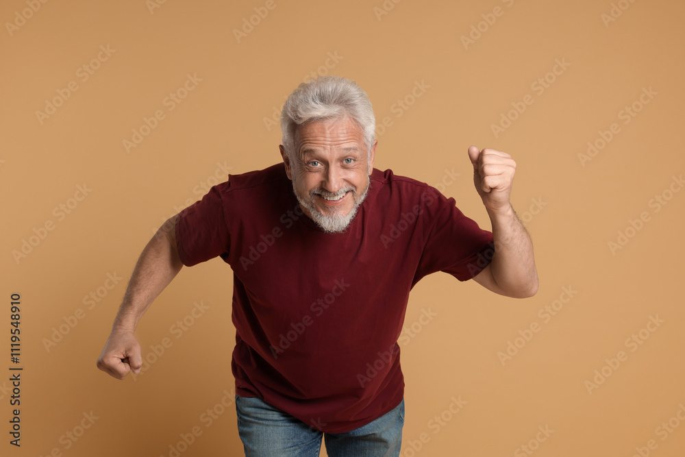 Portrait of happy senior man on beige background Portrait of happy senior man on beige background