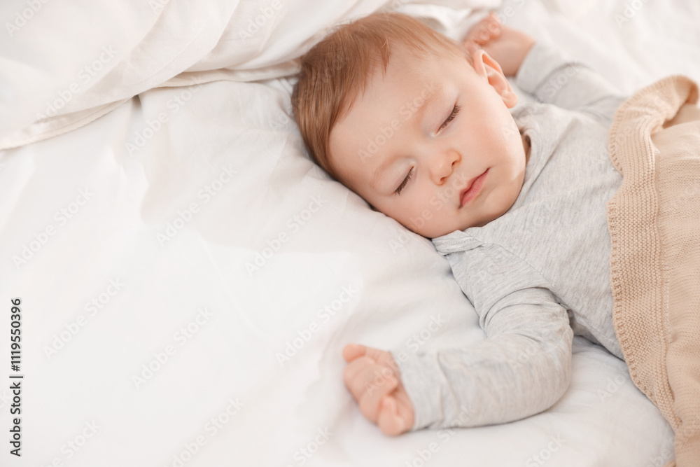 Cute little baby sleeping on bed at home, space for text Cute little baby sleeping on bed at home, space for text