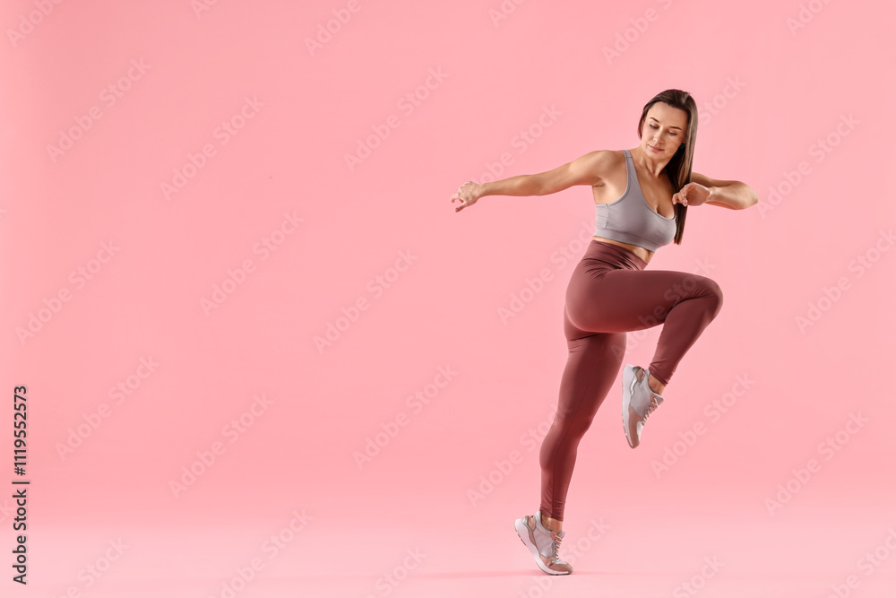 Woman in gym clothes doing exercise on pink background, space for text Woman in gym clothes doing exercise on pink background, space for text