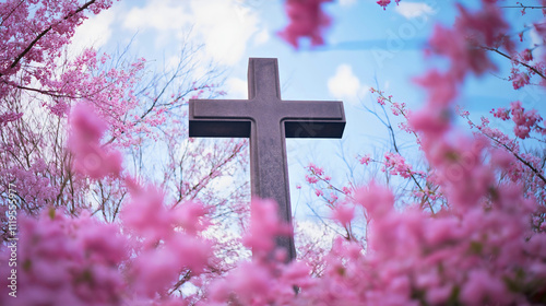 A Wooden Cross Surrounded by Vibrant Pink Blossoms and Spring Flowers, Symbolizing Faith and Spirituality in a Peaceful Garden Setting, Embracing the Beauty and Tranquility of Nature's Springtime Bloo photo