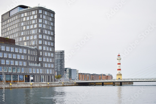 Malmo University building reflected in water.