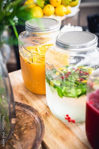 Beautiful, colorful Handmade fresh juices and lemonades in big in big jar with with lemon, orange and fruits