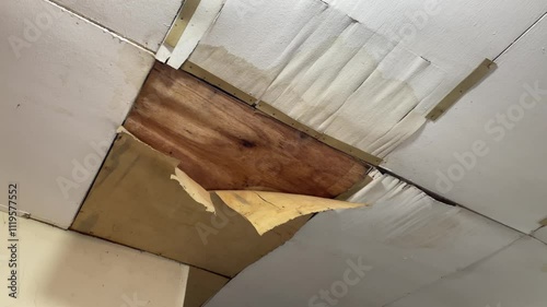 The house ceiling made of plywood peeled off due to rainwater. The house ceiling leaked.. House The plywood ceiling peeled off