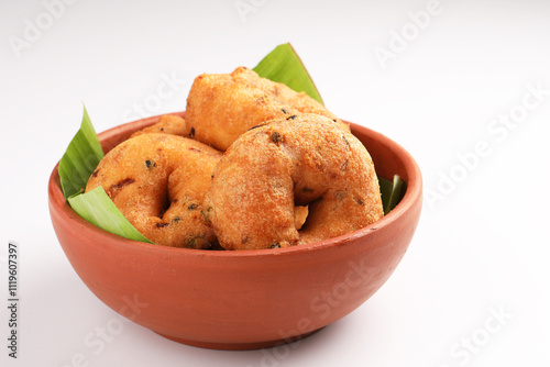 Medu Vada, a popular South Indian food served with Sambar ,Green coconut chutney ,Vada ,Medu vadai with sambar - Popular South Indian snack photo