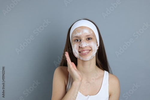 Wallpaper Mural Teenage girl with cleansing foam on her face against grey background, space for text. Acne treatment Torontodigital.ca