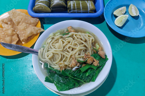 Indonesian food - Pangsip noodles, crackers, buras and oranges on the dining table