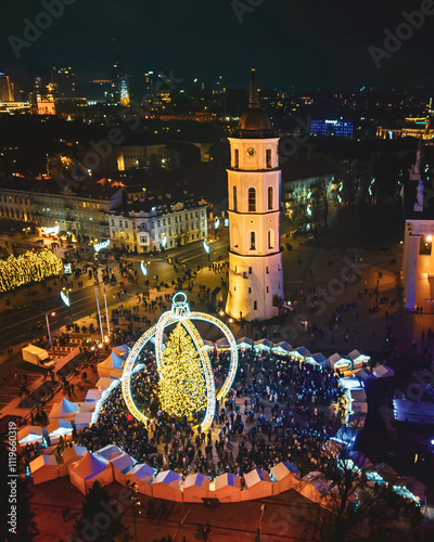 Vilnius, Lithuania - 30th november, 2024: aerial top down view cathedral square and Xmas market visitors sightseeing beautiful Xmas tree in city Vilnius - the european capital of Christmas 2025 photo