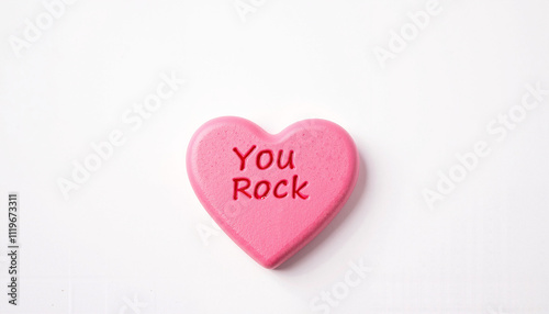 Pink heart-shaped candy saying 