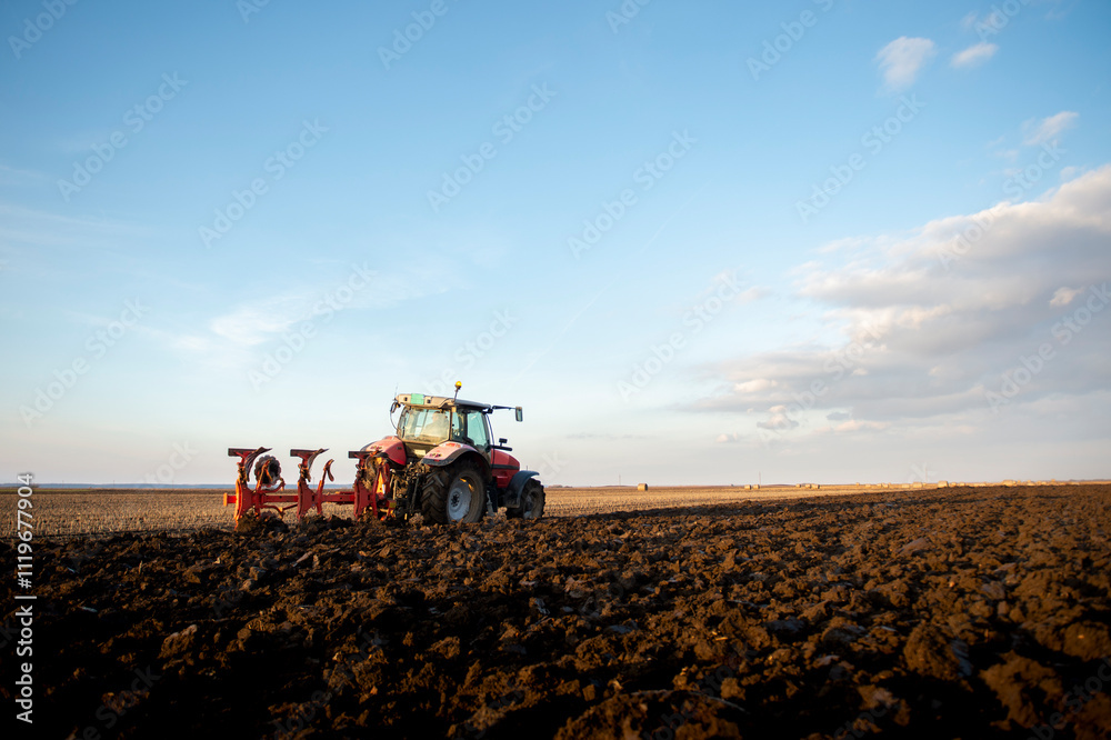 Fototapeta premium Tractor working in the field