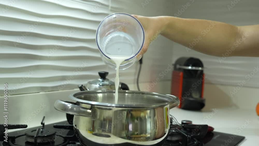 Milk is poured into a saucepan. Cooking.