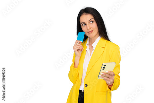 Young businesswoman in a yellow blazer using a smartphone and credit card