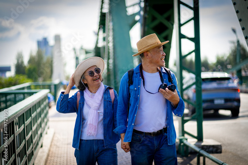 Photography Asian retired couple happily hang out together in city full buildings in capital