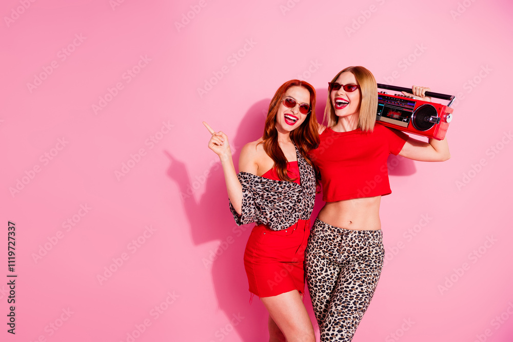 Photo of gorgeous cheerful positive girls wear stylish clothes celebrate party isolated on pink color background Photo of gorgeous cheerful positive girls wear stylish clothes celebrate party isolated on pink color background