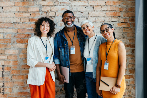Canvas-taulu Group of professionals smiling and standing together in front of a brick wall
