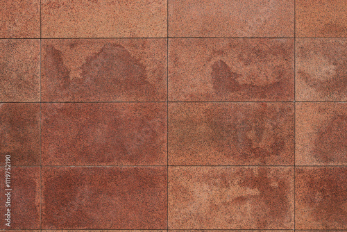 Granite tile wall, bricks, memorial cladding. Even rectangular red blocks, background. smooth surface of treated natural stone.