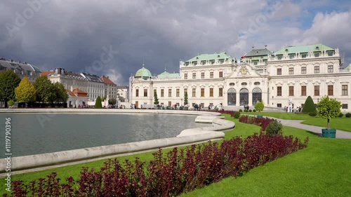 Famous Schloss Belvedere or Upper Belvedere. Beautiful view of Castle illuminated by the sun with storm clouds in the sky.