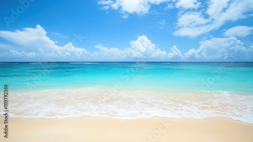 Serene beach scene with turquoise water, white sand, and blue sky.