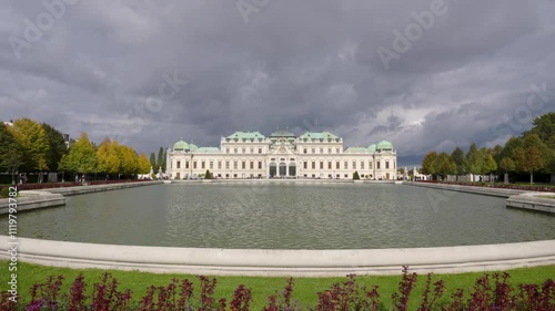 Belvedere Castle (Schloss Belvedere), popular tourist attraction in Vienna, Austria. Beautiful view of Castle illuminated by the sun with storm clouds in the sky.