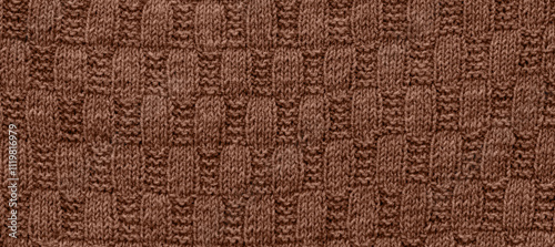 Texture of smooth knitted sweater with pattern. Handmade knitting wool or cotton fabric texture. Background of Large knit pattern with knitting needles or crochet.  Mocha Mousse colour of 2025 year photo