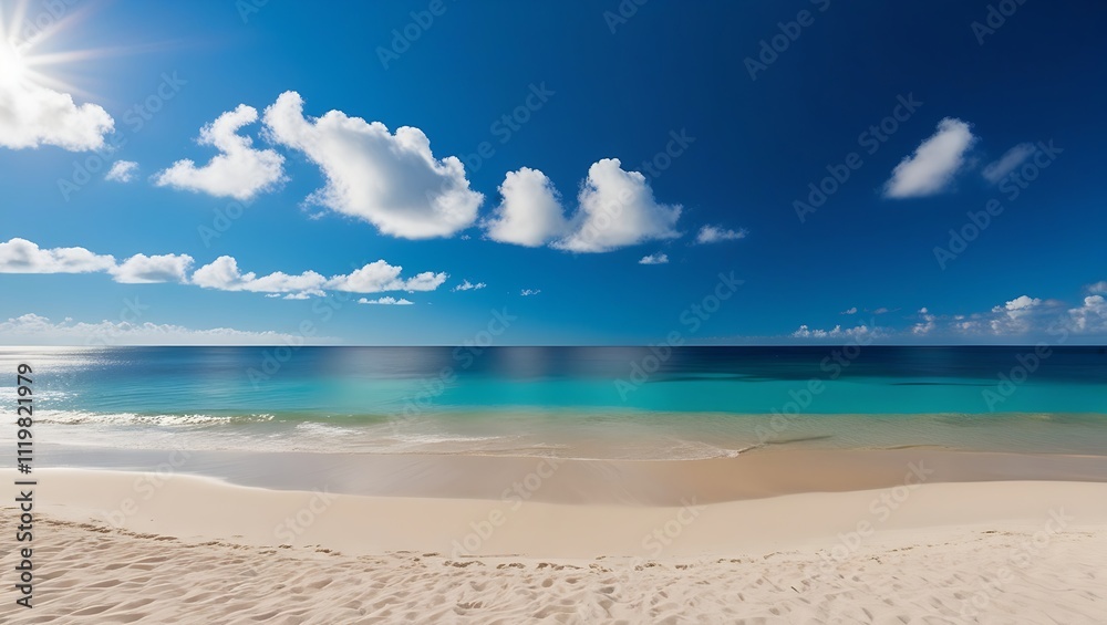 Obraz premium Panoramic photograph of a serene beach with soft beige sand, turquoise ocean waves, and a clear blue sky dotted with white clouds under the radiant sun.