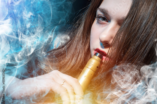 Woman smokes vape. Portrait...