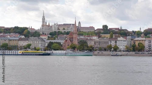Budapest, Hungary - October 12, 2024: View of Buda Castle and Fisherman's Bastion with the Danube River in the Foreground, Showcasing Historic Architecture in the Heart of Budapest, Hungary