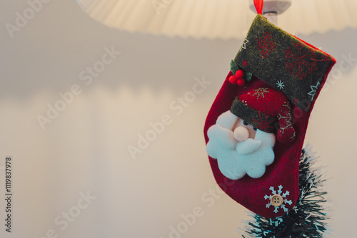 s stocking with Santa design hanging on lamp, festive decor photo