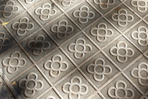 Sidewalk with panot (tiles with flower inside) in Barcelona, Catalonia, Spain, Europe