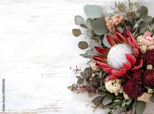 Obraz na płótnie A bouquet of Australian native flowers, including an exaggerated waratah and eucalyptus leaves, arranged on the right side with space for text at the top. w salonie