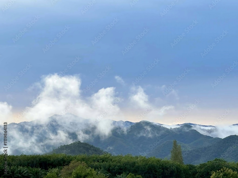 Obraz premium Serene Mountain Landscape with Misty Clouds