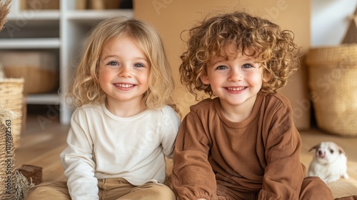 A pair of smiling children sit indoors, bathed in soft natural light, their expressions highlighting a sense of joy and companionship, capturing childhood warmth. photo