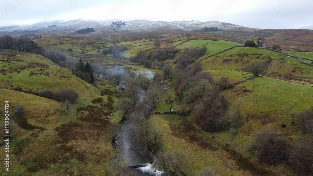 Aerial view of Widdale Beck, tributary of River Swale with snow on far hills Aerial view of Widdale Beck, tributary of River Swale with snow on far hills