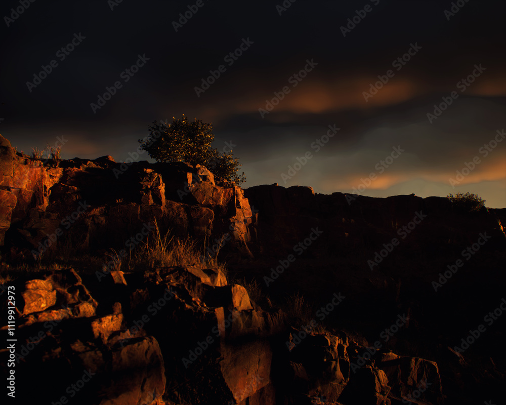 Quarry slate with some trees under a dark cloudy sky during sunset. 3D render.