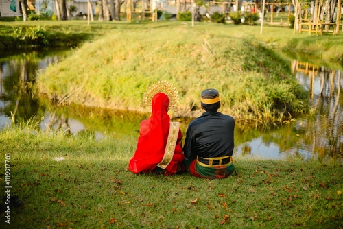 Portrait of Asian Men and Women wearing traditional Bugis clothes posing for pre-wedding photo