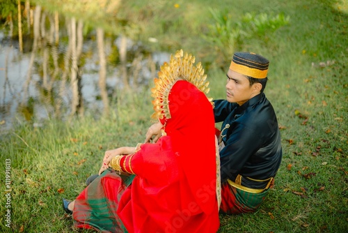 Portrait of Asian Men and Women wearing traditional Bugis clothes posing for pre-wedding photo