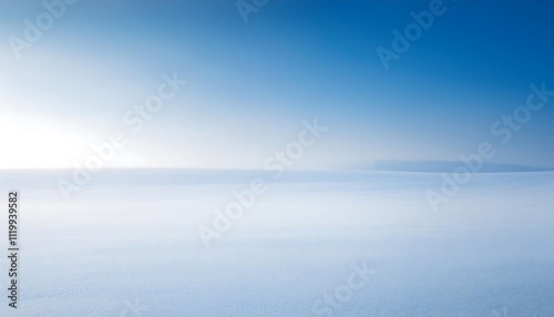 Expansive snowy landscape under a clear blue sky.