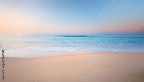 Serene beach at sunset with gentle waves.